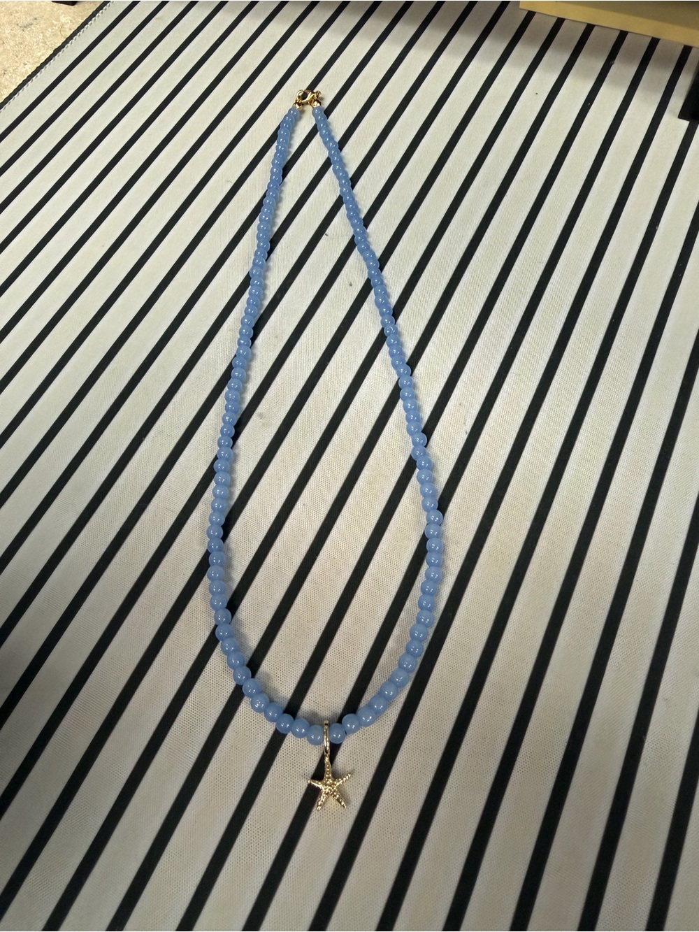 Gold Starfish Pendant Necklace with Light Blue Beads